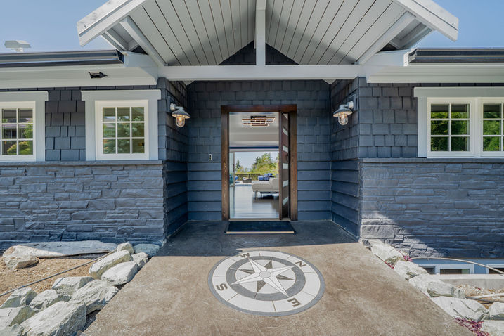 Exterior entrance of Seattle home with blue siding and compass walkway design