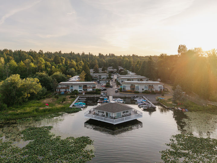 Aerial view of waterfront homes surrounded by trees in Puget Sound