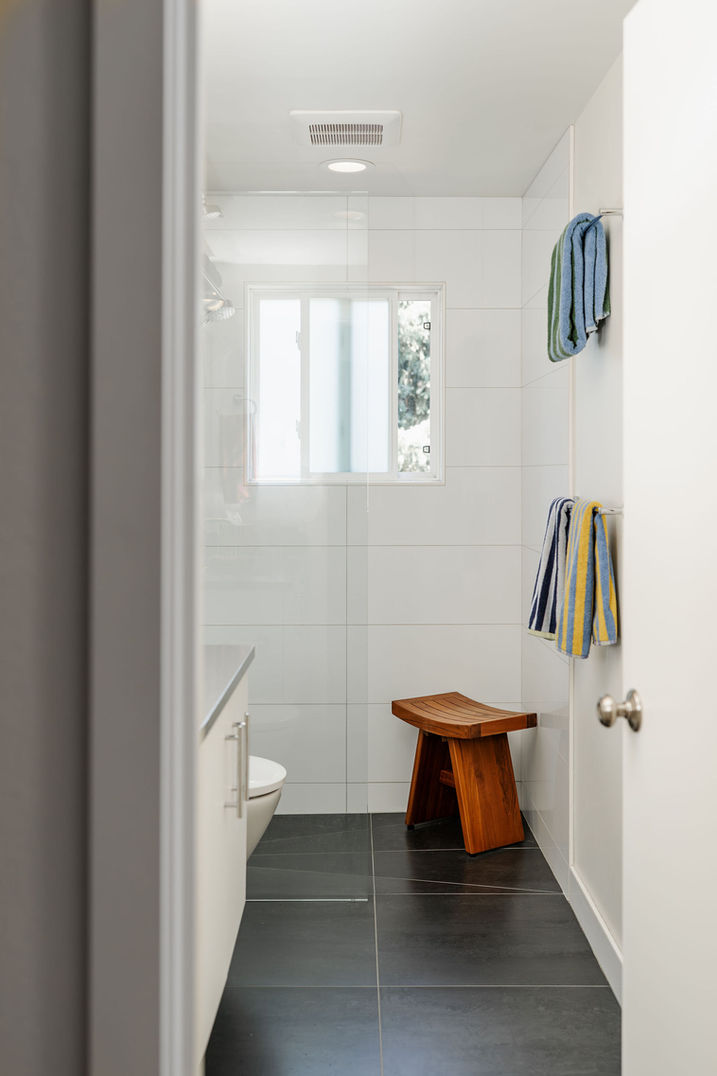 bathroom with bench and coat hooks in contemporary Seattle home
