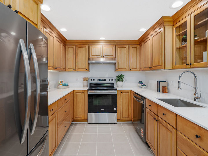 Kitchen with stainless steel appliances and white countertops