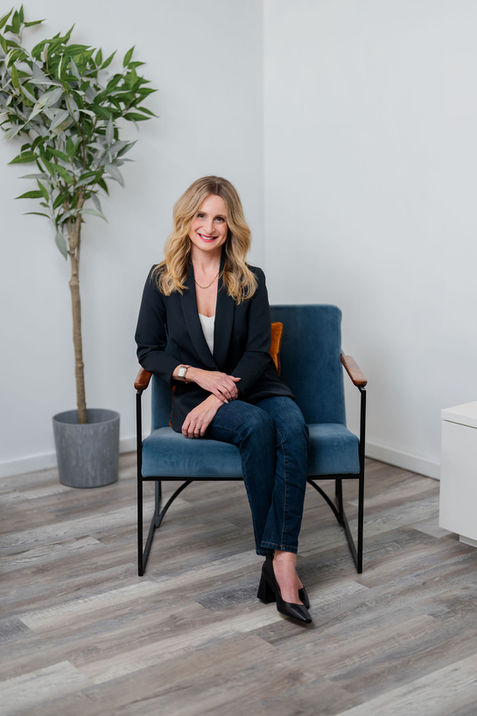 Professional woman seated for relaxed personal brand portrait