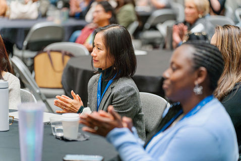 Attendees clapping during seminar in Seattle