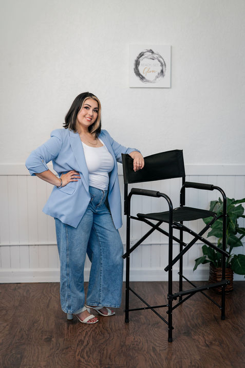 Creative professional posing in studio chair for personal brand photography