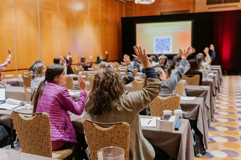 Attendees seated in conference room during presentation