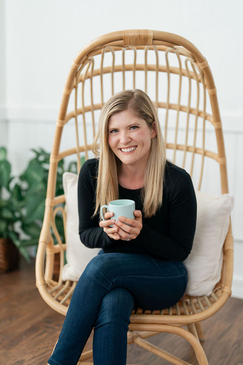 Health professional holding coffee mug in relaxed studio portrait