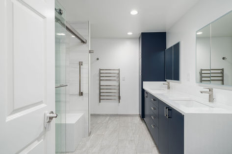 Bathroom with double vanity, glass shower, and modern fixtures
