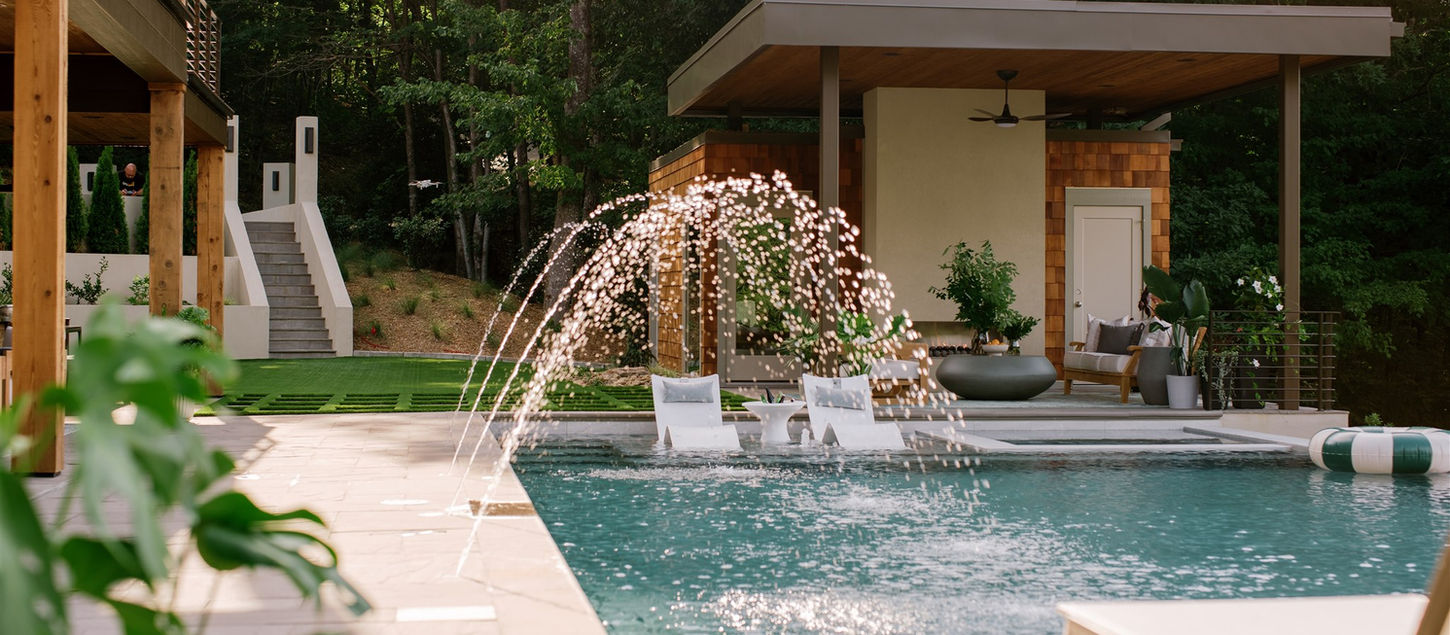 Modern pool house and pool with fountains and plants