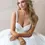 Thumbnail: Elegant woman in white wedding dress with blonde hair looking away.