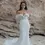Thumbnail: Elegant woman in white wedding dress, Bow Two Tier Veil, posing by the beach.