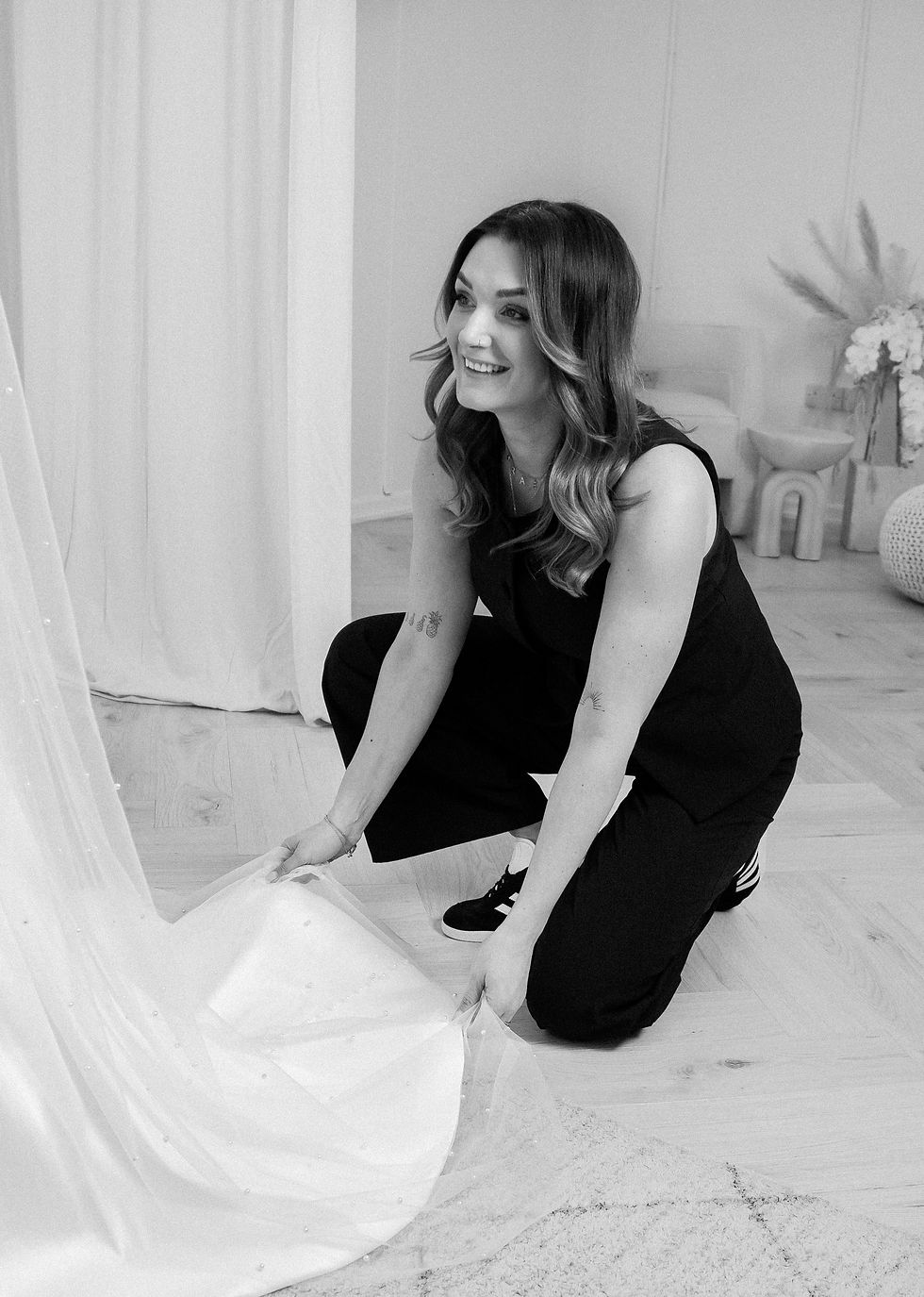 High angle view of bridal consultant assisting bride with wedding dress fitting
