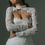 Thumbnail: Woman wearing a white lace dress, Chosen by Khya, Orelle. Elegant bridal attire