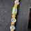 Thumbnail: Large Glass Barrel Beads Facetted in Gold Necklace