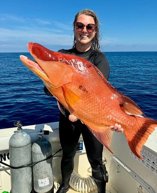 Photo of Rx owner Sarah Doss with the hogfish she speared that will go on that night's menu at Rx Chicken & Oysters