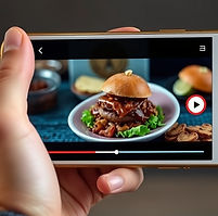 Gold cell phone showing short food video .jpg