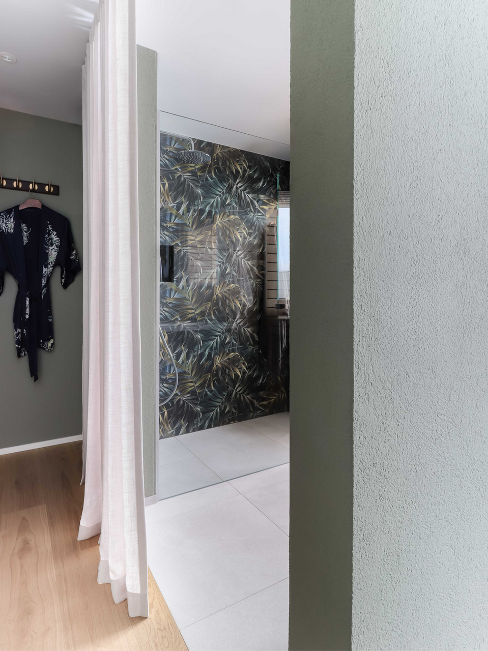 Master suite with integrated private sauna and layered natural materials.
