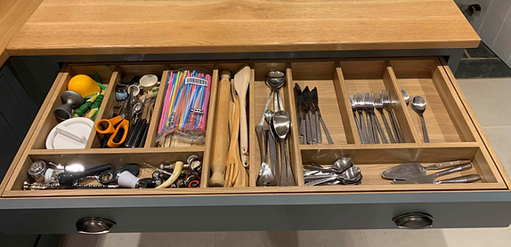 Wide oak kitchen drawer featuring custom dividers for mixed cutlery and utensils, with efficient organisation for daily kitchen tools.