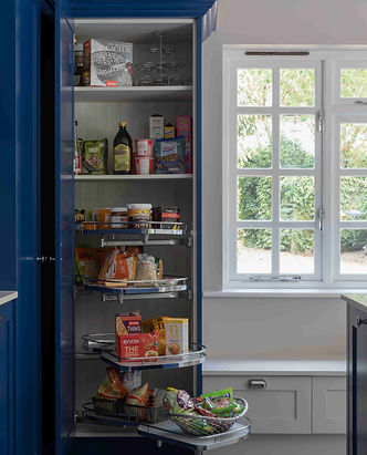 Corner tall cabinet with LeMans swing-out trays, ideal for snacks and baking goods. Chrome arms with soft-close motion.