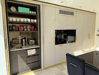 Contemporary kitchen in Stevenage featuring a pocket door breakfast station, Miele appliances and gold detailing