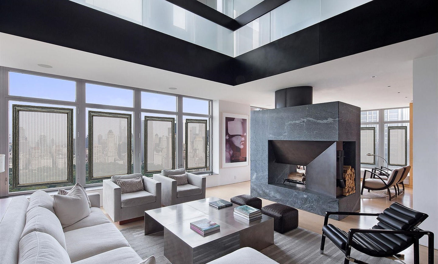Luxury condo living room with black oak skylight covers, gray light‑filtering fabric, floor‑to‑ceiling windows, modern furniture, and city skyline views.