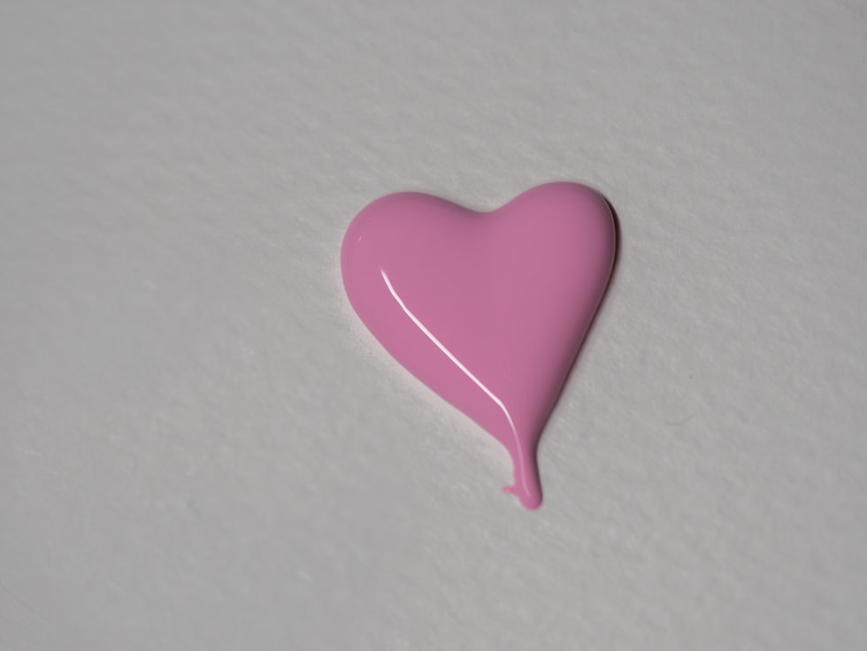 Pink heart-shaped paint splatter on white textured background, creating a whimsical and artistic mood.