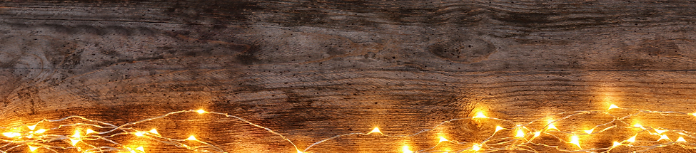 Wood board with fairy lights across the bottom of the image.