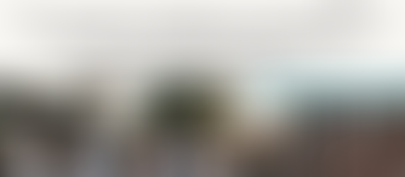 Group of people socializing outdoors at sunset near brick wall. Empty glass on table. Headline Text: SPECIAL FEATURE: The Shire Exit Guide - The Top 10 Ways Locals Perfect The Art of Leaving. After an extensive investigation by our Social Affairs Desk, consider this your official field guide to leaving social situations the Shire way. Sutherland Shire Gazette.