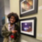 Solomon Sloan with his framed illustration of "The Meditiation of Birds" featuring a white bird in an airplane over an ocean at night.
