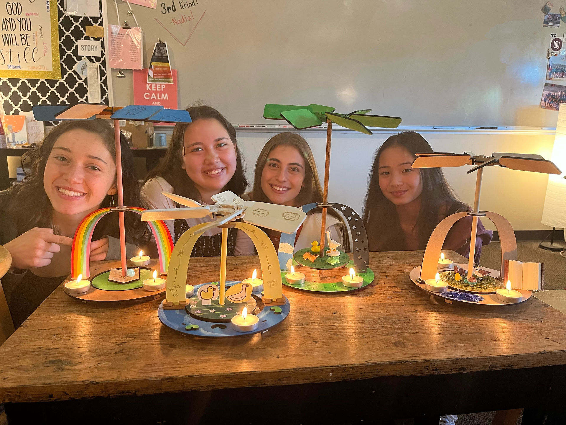 A group of female students in front of their projects 