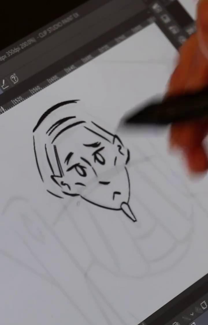 A blurred hand sketching the pharaoh's face on a tablet.