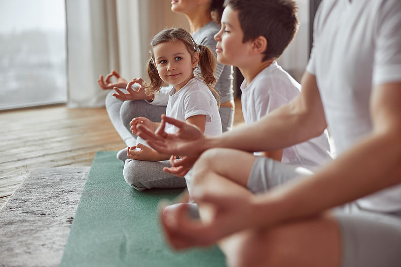 happy-little-girl-practicing-meditation-with-famil-2021-11-02-03-05-30-utc.jpg