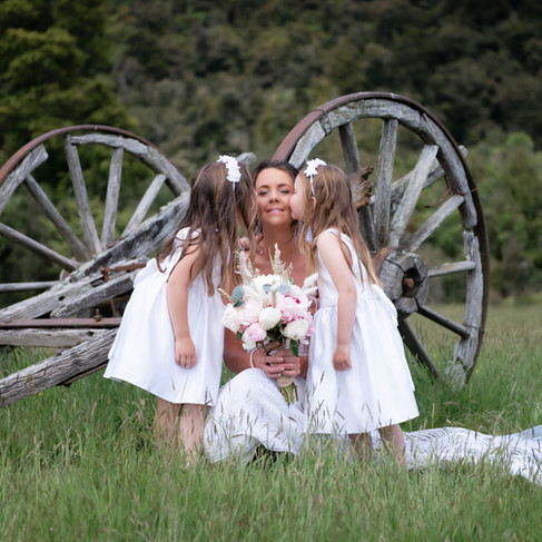 Bride And Flower Girls Beside Wagon Wheel