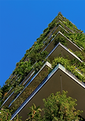 A tall building with plants and vegetation on each level