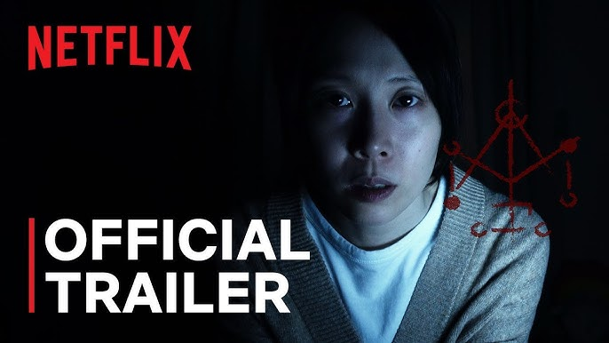 A person looks intently at the camera in a dark setting. Netflix logo, "Official Trailer" text, and a red symbol are visible. Mood is intense.