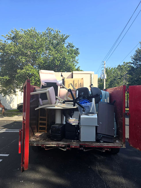 Local cleanout crew loading truck for junk and estate removal
