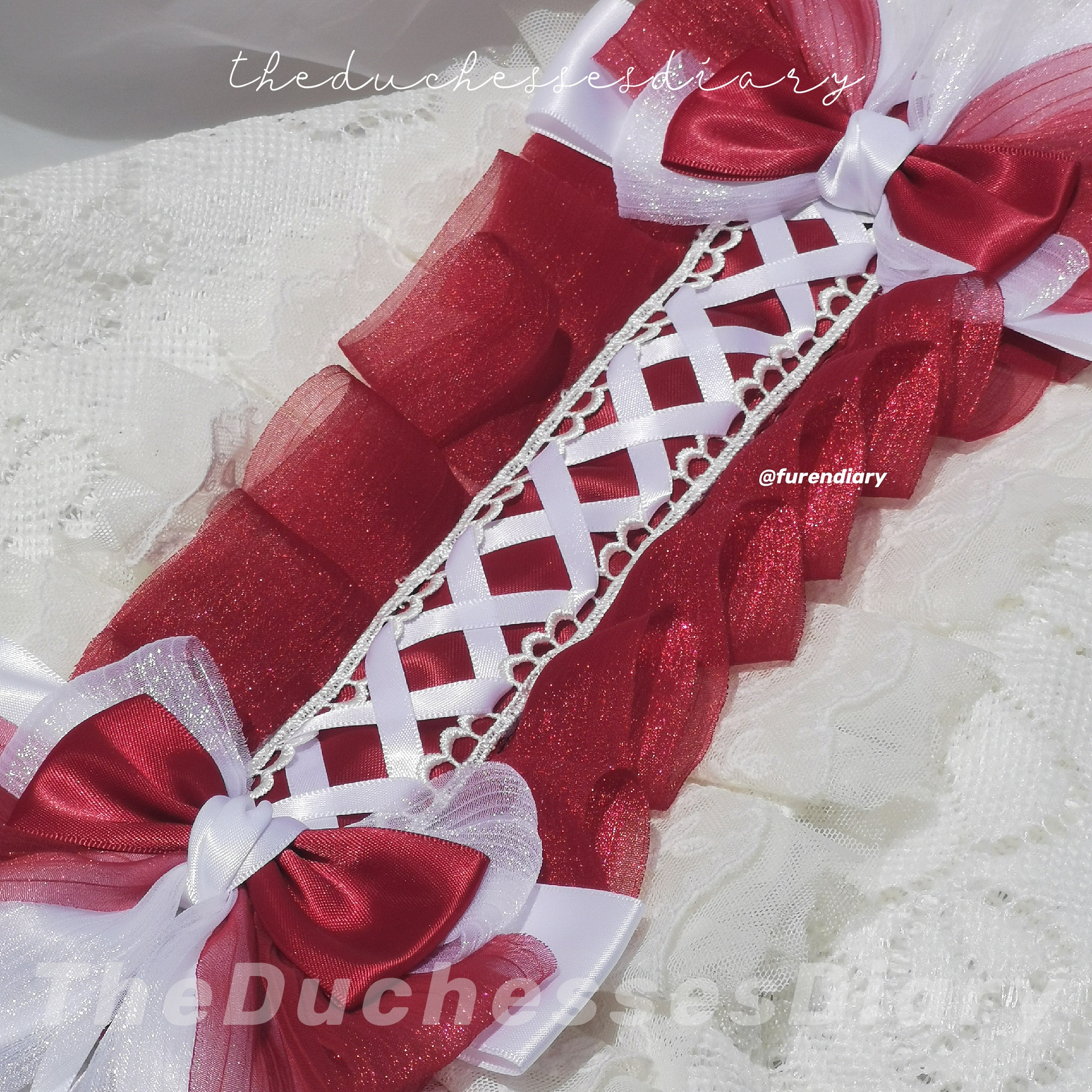 Red Headdress with white ribbon laced in the middle, accompanied with 2 bows on each side which are Red & White