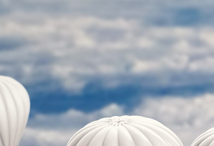 One red balloon rising above a crowd of white balloons