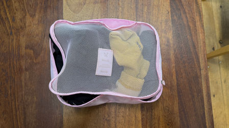 Packing cube with socks and undergarments inside mesh pouch for organized travel packing