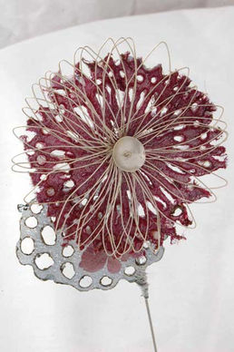 Close-up of a maroon flower with wire detailing and silver base.