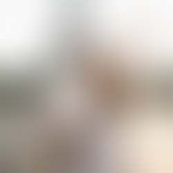 Woman in white holds phone showing aussieroam.com.au, smiles, raises arm, with Eiffel Tower in background, sunny day, joyful mood.