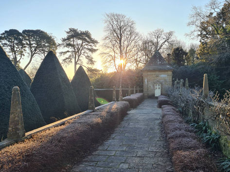 A sunrise over one of the garden pavillions at Athelhampton