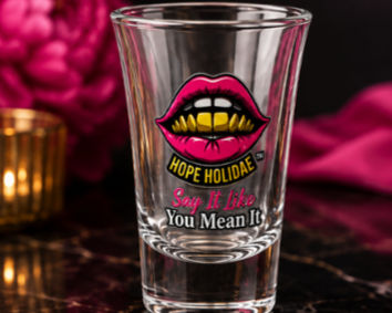 Clear Hope Holidae shot glass with pink lips logo and Say It Like You Mean It design