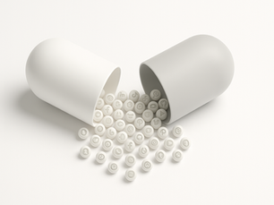 A pill opened in half with dust of social media logos