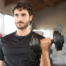 a man focused looking strong doing bicep curls