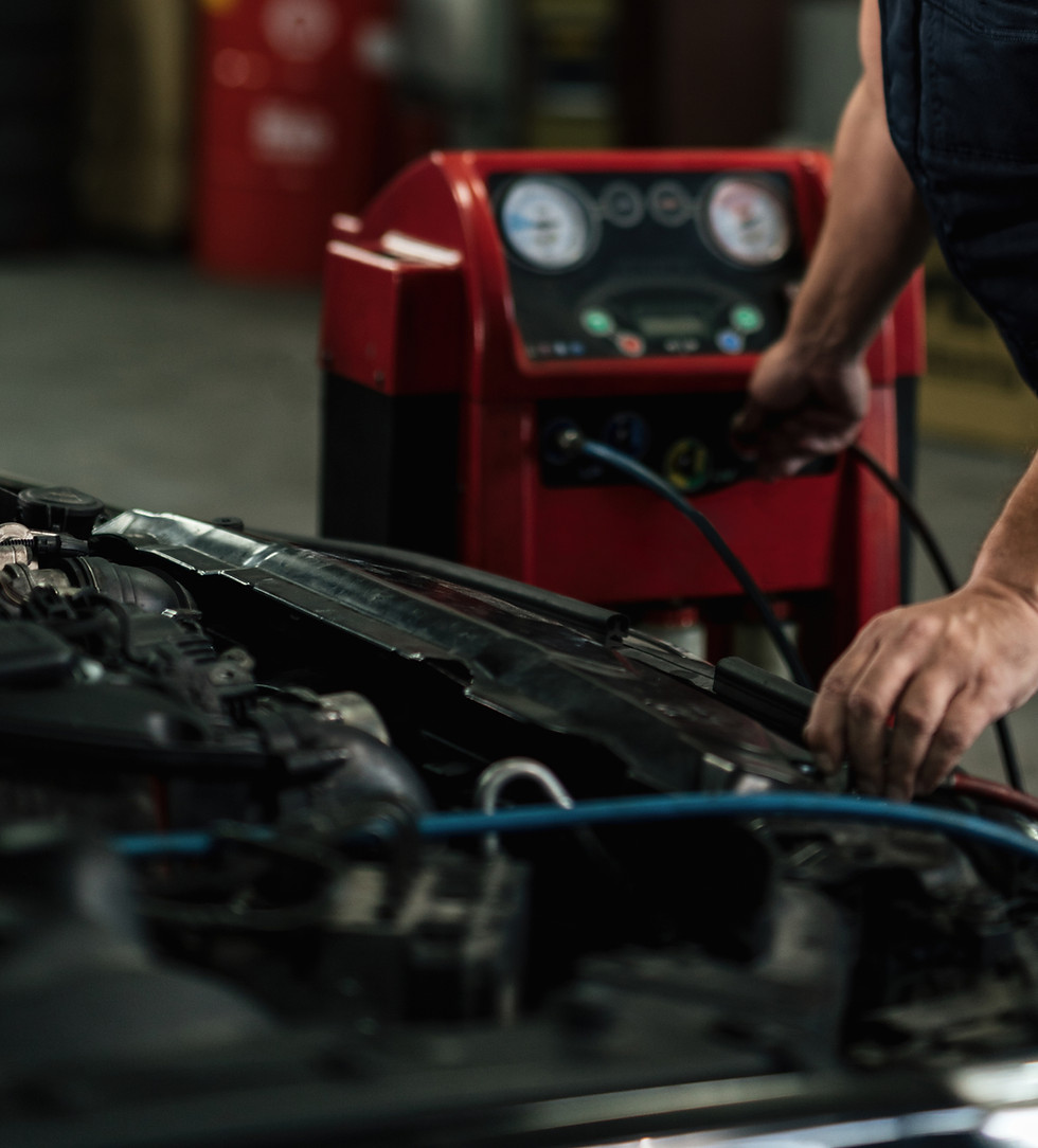 mid-adult-mechanic-using-diagnostic-tool-while-repairing-air-conditioning-system-car-auto-