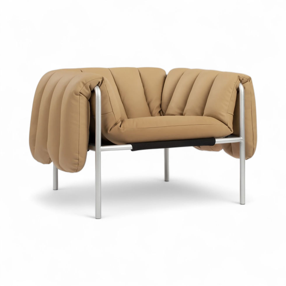 Tan leather armchair with metal frame and a unique, pleated design