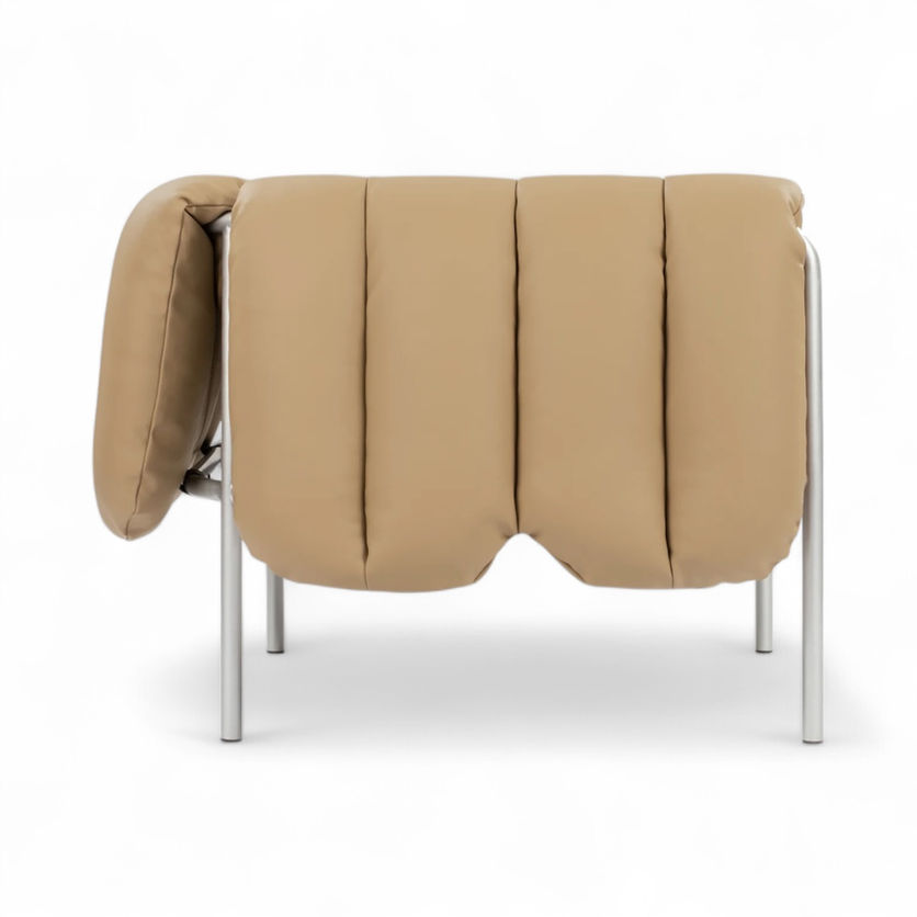 Tan tufted chair with silver legs