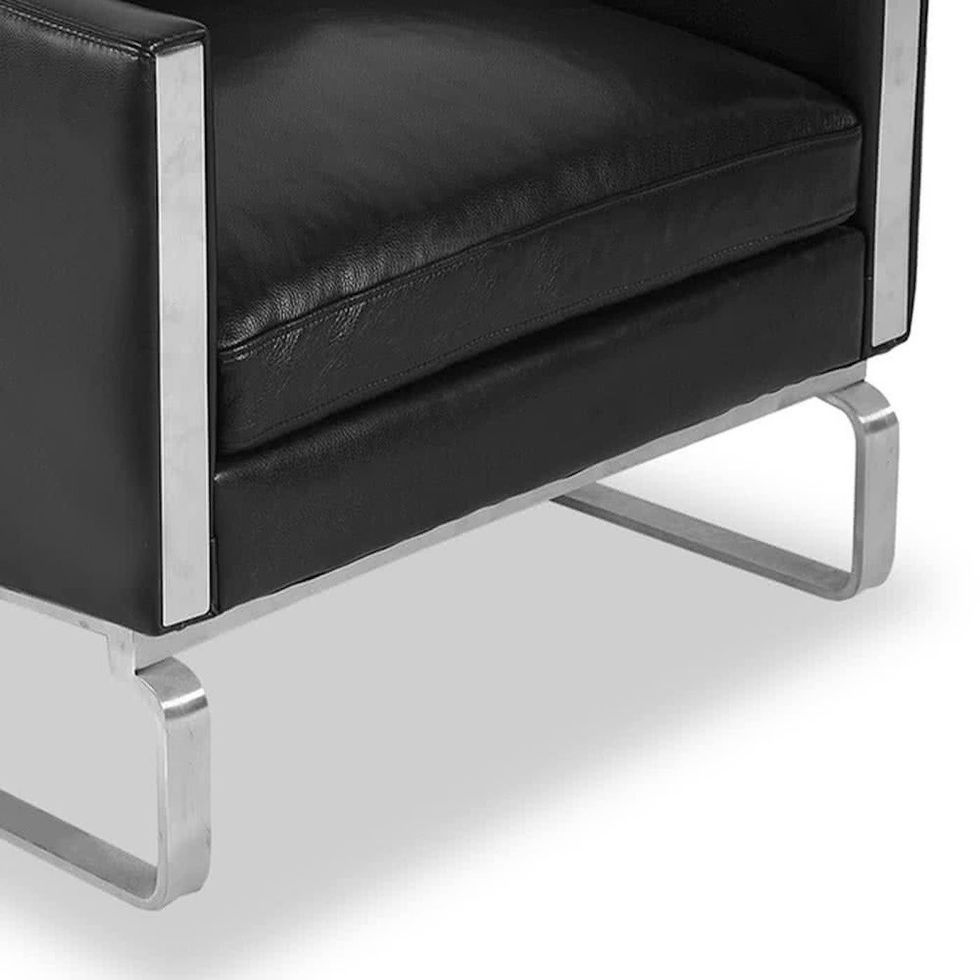 Close-up of a black modern chair with stainless steel frame