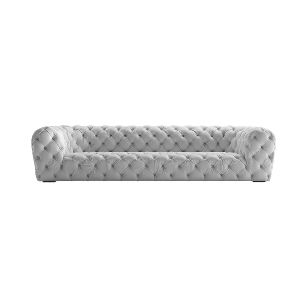 Elegant gray tufted sofa on a white background. Strips Sofa Nue Modern.