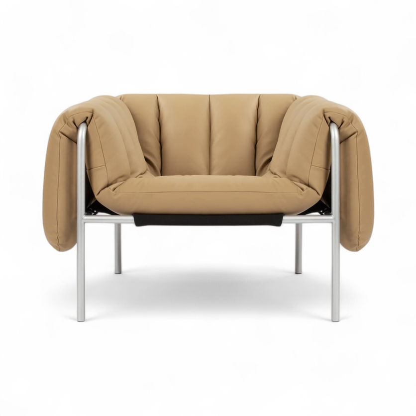 Tan leather armchair with a metal frame