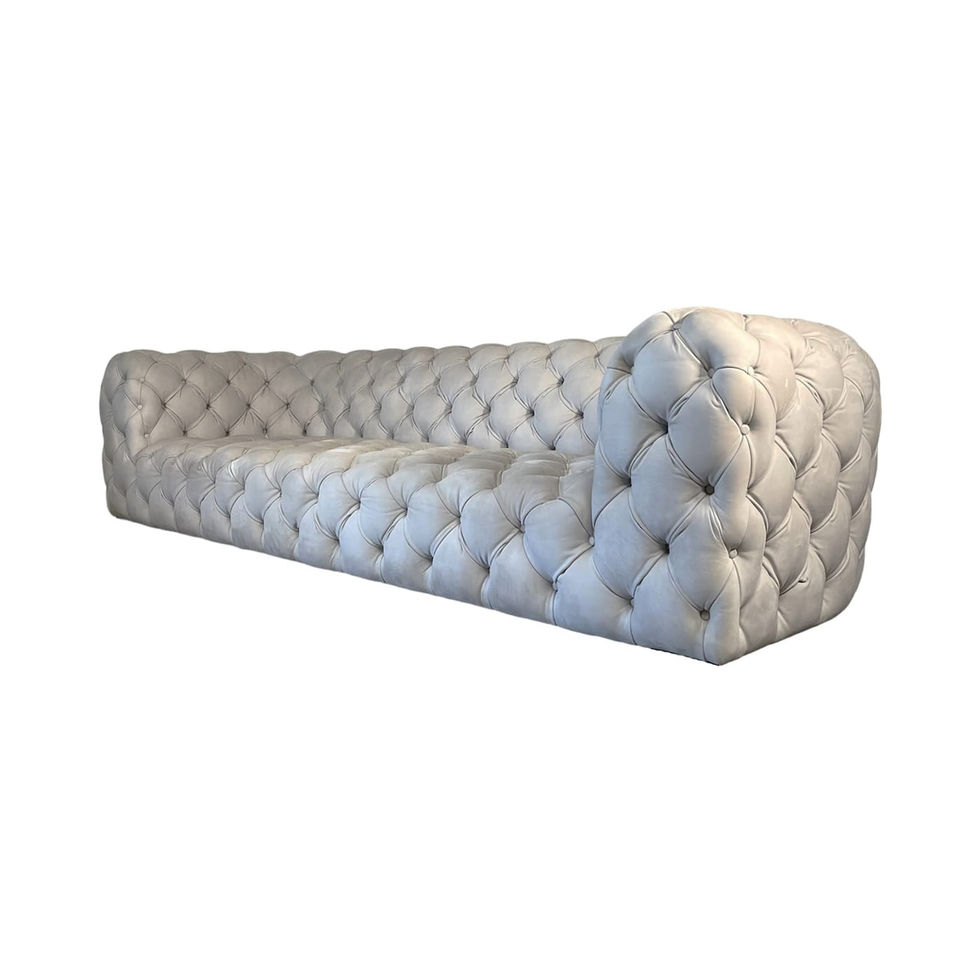 Tufted white sofa angled on white background, Nue Modern furniture decor.